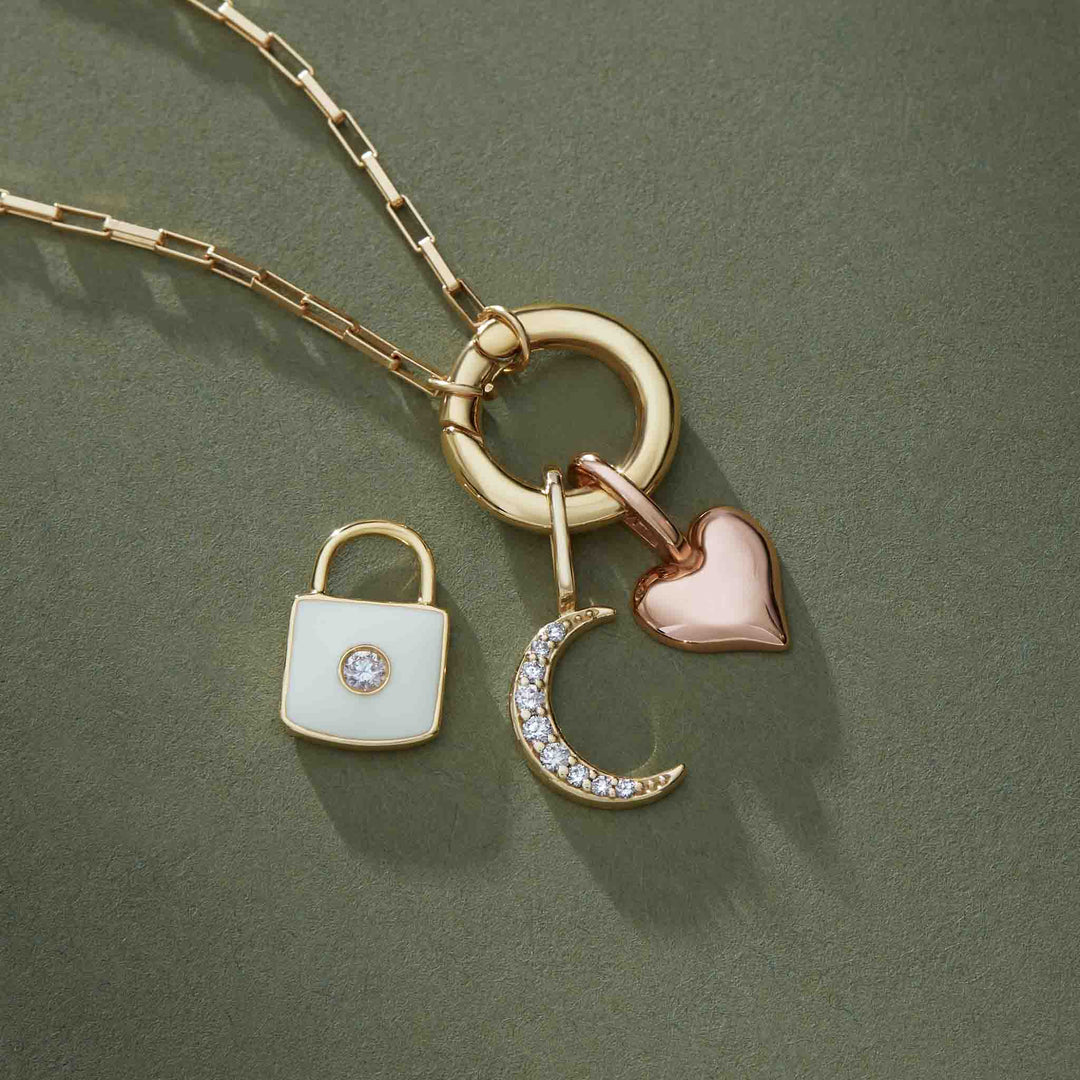 Elongated box necklace inspiration featuring a 14k gold circle clasp and heart, lock, diamonds moon pendants.