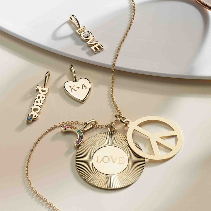 The heart-shaped pendant in the center of the picture is engraved with a customized message.